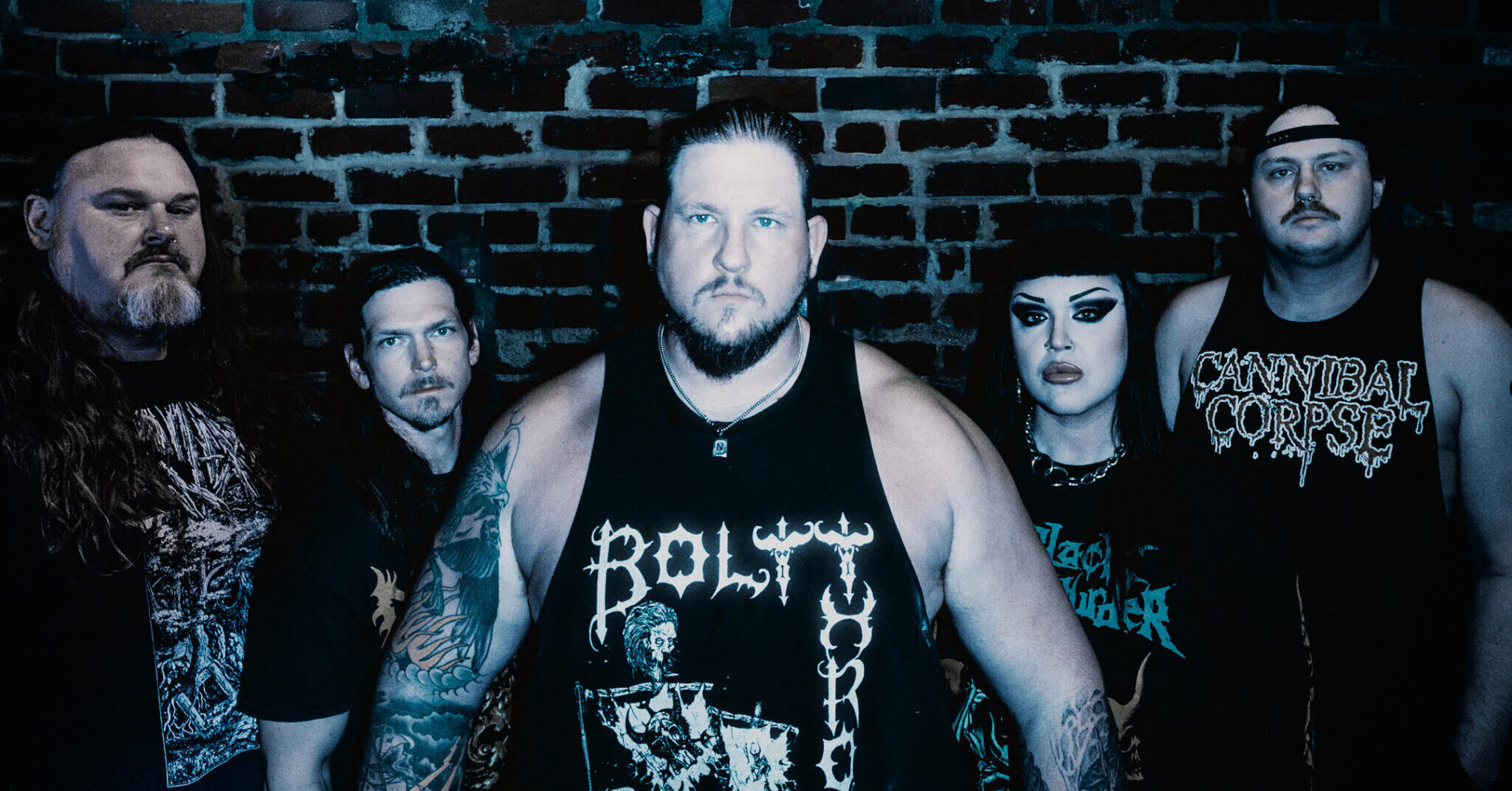 Frozen Soul band members posing in front of a brick wall