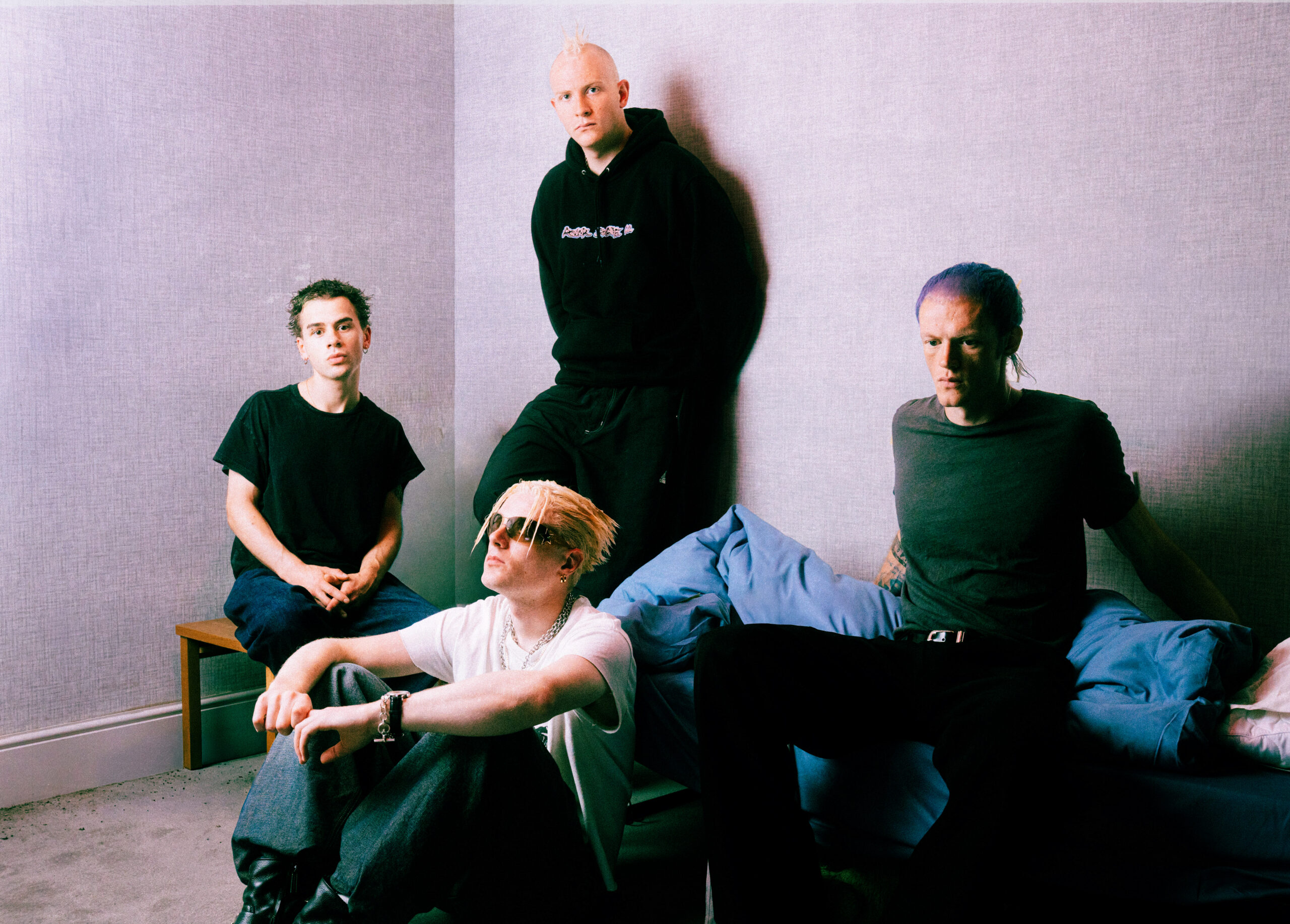 Bleach 9:3 band members posing in a room with textured walls